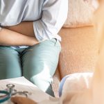 Abdominal pain patient woman having medical exam with doctor on illness from stomach cancer, irritable bowel syndrome, pelvic discomfort, Indigestion, Diarrhea, GERD (gastro-esophageal reflux disease)