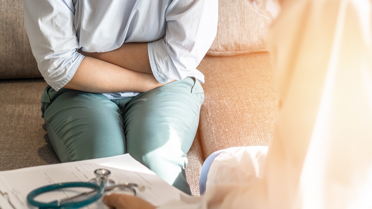 Abdominal pain patient woman having medical exam with doctor on illness from stomach cancer, irritable bowel syndrome, pelvic discomfort, Indigestion, Diarrhea, GERD (gastro-esophageal reflux disease)