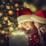 Christmas magic gift, happy family mother and daughter baby girl