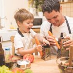 Father is cooking with his son