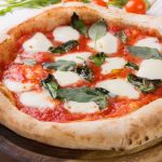 78949488 - whole neapolitan pizza served on wooden board